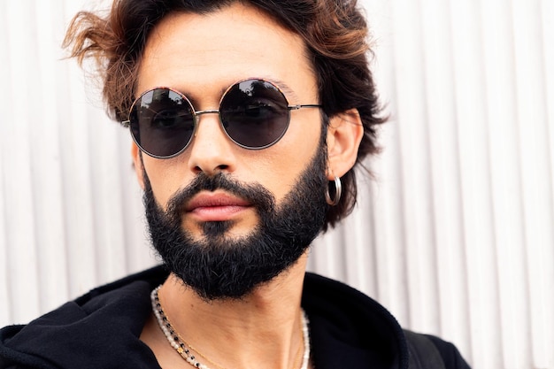 Portrait of a young man with beard and sunglasses