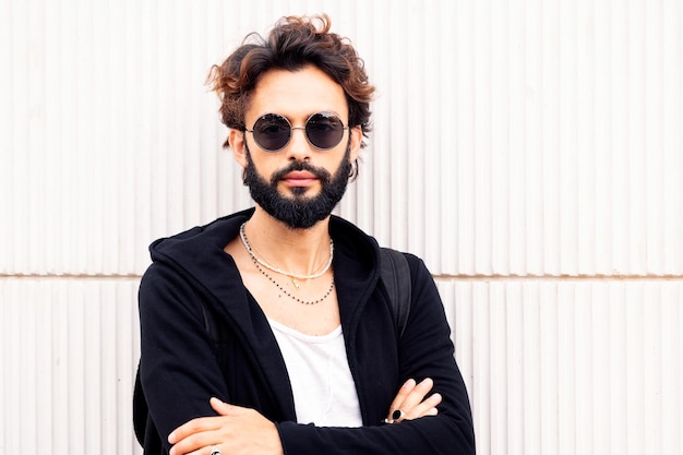 Portrait of a young man with beard and sunglasses