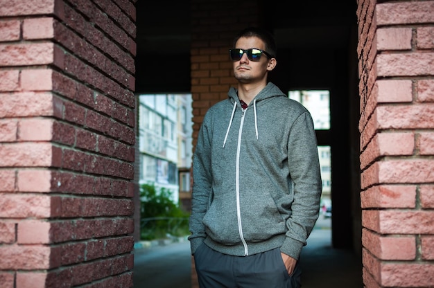 Portrait of a young man with glasses on the street