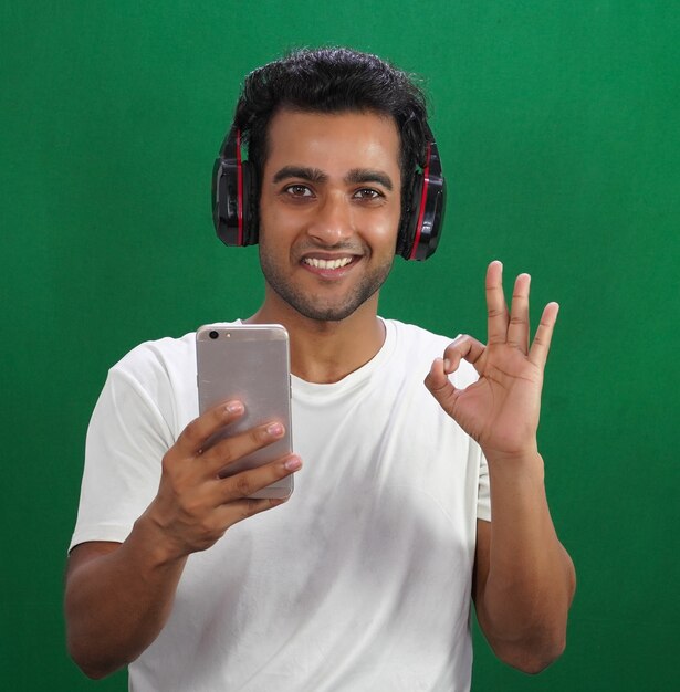 Portrait of young man with headphones and phone