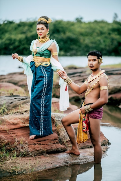 Portrait of Young man and woman wearing beautiful traditional costume pose in nature in Thailand