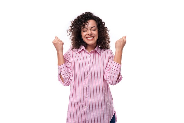 Portrait of a young office secretary woman dressed in a striped pink shirt on a white background