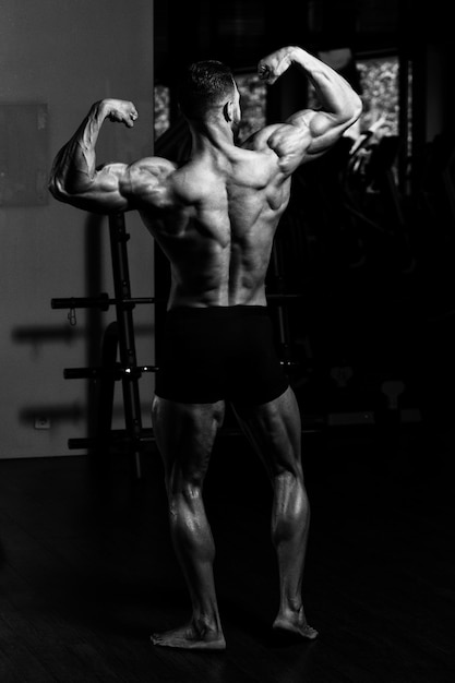 Portrait Of A Young Physically Fit Man Showing His Well Trained Body  Muscular Athletic Bodybuilder Fitness Model Posing After Exercises