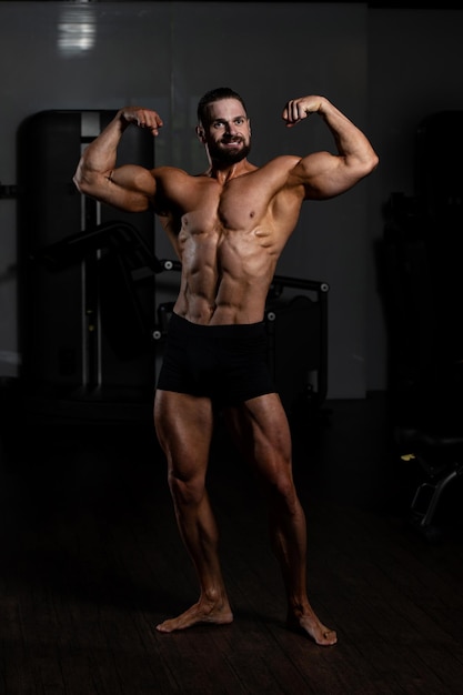 Portrait Of A Young Physically Fit Man Showing His Well Trained Body  Muscular Athletic Bodybuilder Fitness Model Posing After Exercises