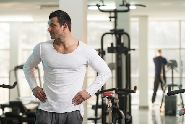 Portrait of a Young Physically Fit Man in White Tshirt Showing His Well Trained Body  Muscular Athletic Bodybuilder Fitness Model Posing After Exercises