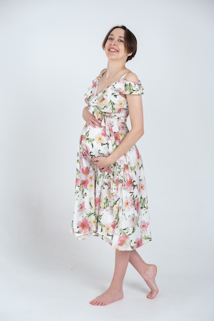 Portrait of young pregnant woman in summer dress