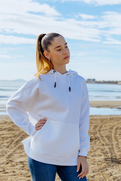 Portrait of a young pretty girl against the background of the sea