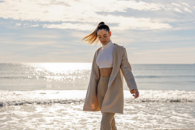 Portrait of a young pretty girl on the background of the sea