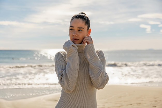 Portrait of a young pretty girl on the background of the sea