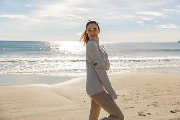 Portrait of a young pretty girl on the background of the sea