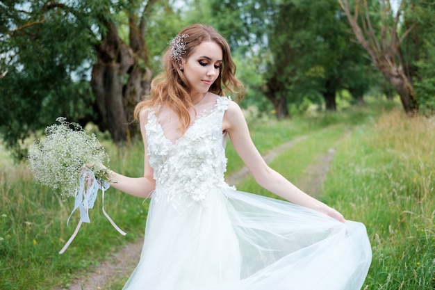 Portrait of young pretty woman in white wedding dress