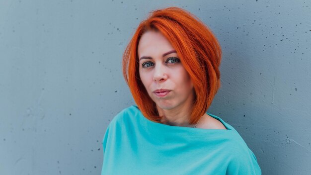 Portrait of young redhaired woman in casual clothes