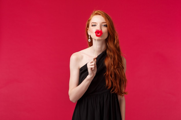 portrait of a young redhead woman with long curly red natural hair