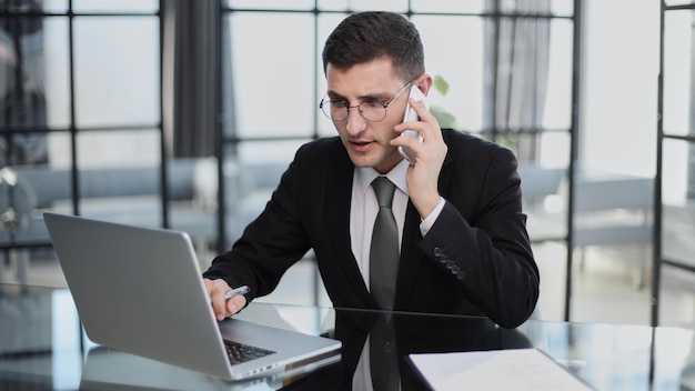 Portrait of a young serious businessman in a casual office