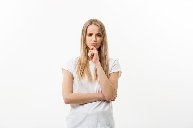 Portrait young serious caucasian woman thinking of something.