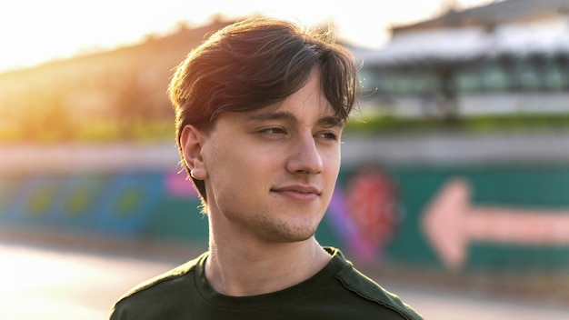 Portrait of a young smiling man at sunset