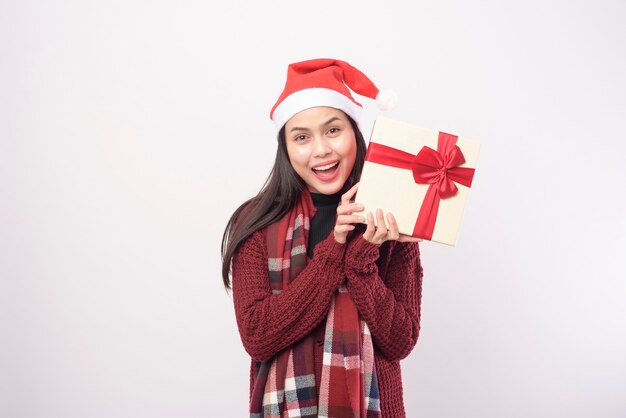 A portrait of young smiling woman wearing red Santa Claus hat