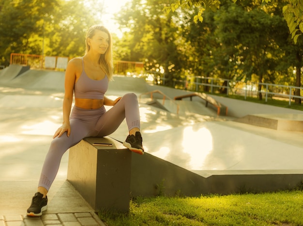 Portrait of a young sports woman in sportswear outdoors. Healthy lifestyle concept. Morning workout