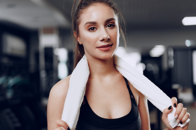 Portrait of a young sporty caucasian woman training in a fitness club