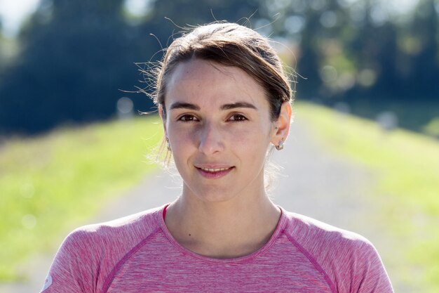 Portrait of young sporty woman in the countryside