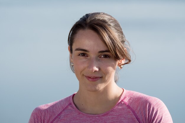 Portrait of young sporty woman in the countryside