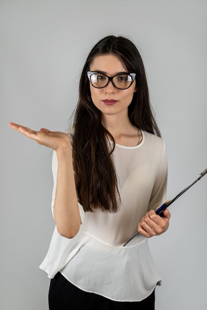 Portrait of a young teacher of younger children with a tablet isolated on a colored background