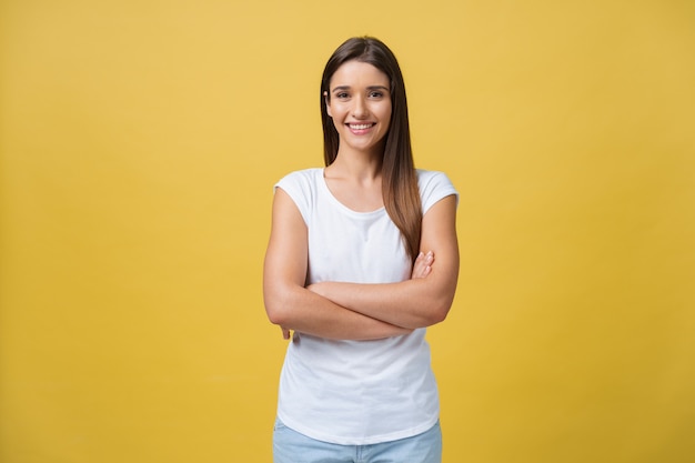 Portrait of young teenage girl with healthy skin wearing striped top looking at camera. Caucasian woman model with beautiful face posing indoors.