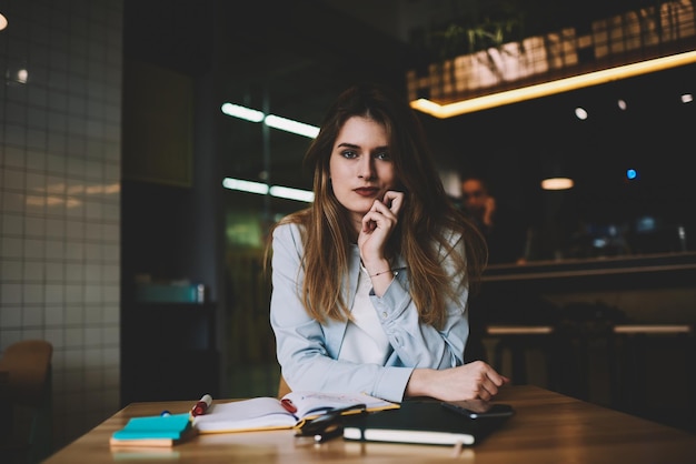 Portrait of young thoughtful hipster girl enjoying time at coffee shop attractive contemplative