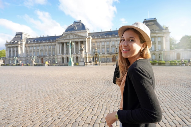 Portrait of young tourist woman visiting on sunset the Royal Palace of Brussels Belgium