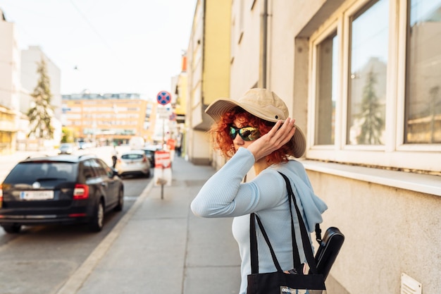 Portrait young woman against backdrop of city life