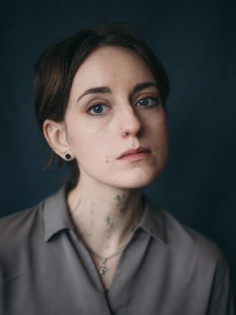 Portrait of young woman against black background