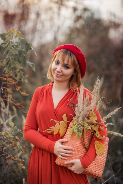 Portrait of young woman in autumn park