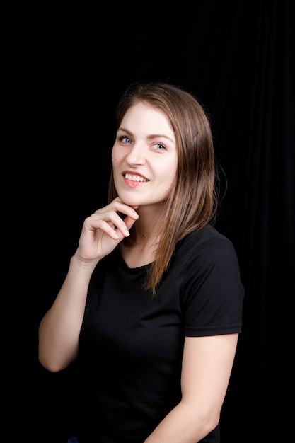 portrait of a young woman in a business suit with hands near the face