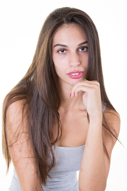 Portrait of young woman casual portrait hand on chin beautiful model posing in studio over white background