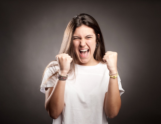 Portrait of a young woman celebrating being a winner