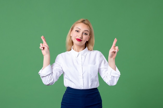 portrait of young woman in conservative clothing green wall college school teacher