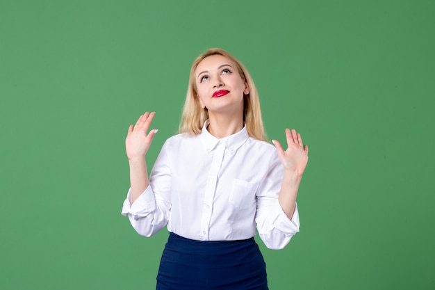 portrait of young woman in conservative clothing green wall female lesson student study