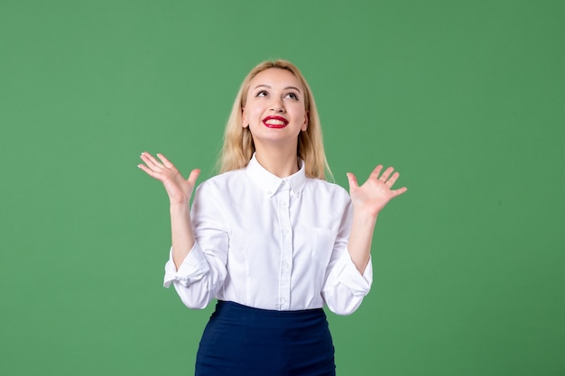 portrait of young woman in conservative clothing smiling green wall female study lesson student