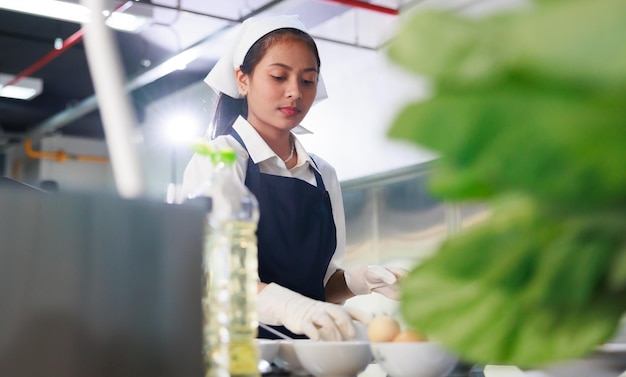 Portrait young woman cooking student Cooking class culinary classroom happy young woman multi ethnic students are focusing on cooking lessons in a cooking school