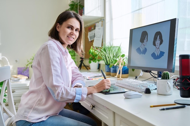 Portrait of young woman designer looking at camera female with graphic tablet