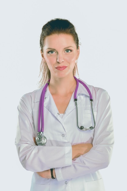 Portrait of young woman doctor with white coat standing in hospital Portrait of young woman doctor