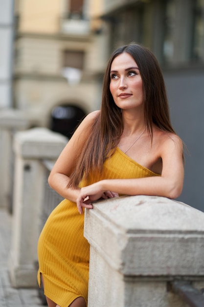 Portrait of a young woman dressed in fashion looking away