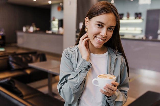 Portrait of a young woman enjoying coffee