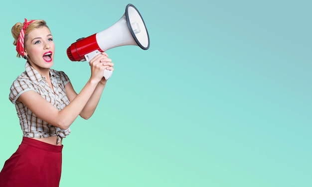 Portrait of young woman holding megaphone