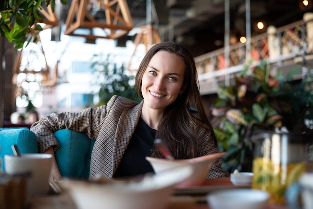 Portrait of a young woman in the interior of the restaurant