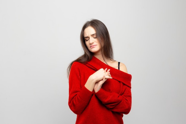 Portrait of a young woman looking bored isolated on whitegray background