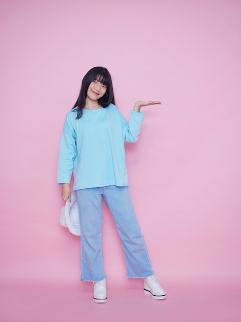 Portrait of young woman on pink wall