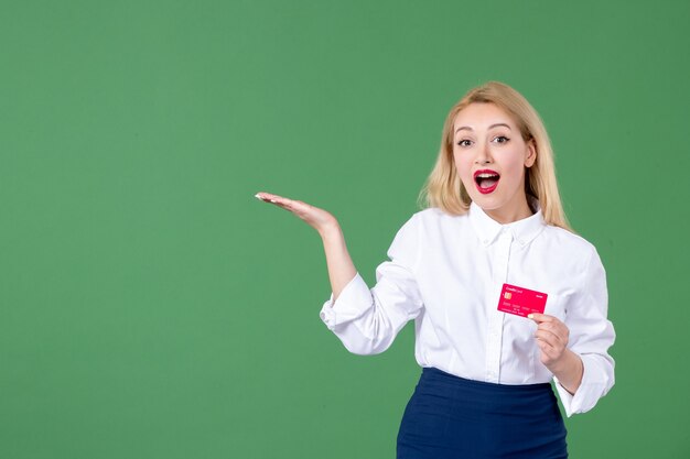 portrait of young woman posing with credit card green wall school teacher money business bank