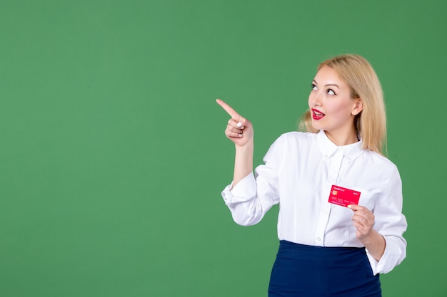 portrait of young woman posing with credit card green wall teacher bank money business