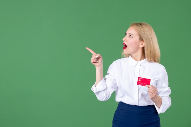 portrait of young woman posing with credit card green wall teacher bank school business